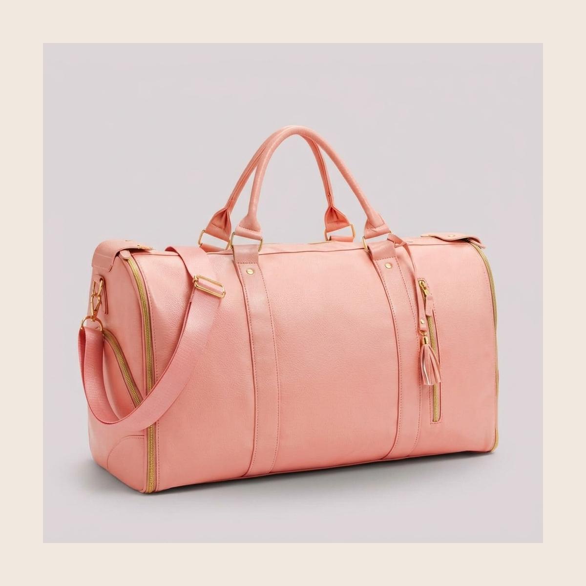 The rose pink Luhxe Travel Bag 2.0 standing upright, soft leather with gold zippers and detachable strap
